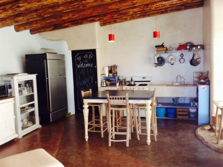 Todos Santos Earthship kitchen with a vigas-and-latilla ceiling