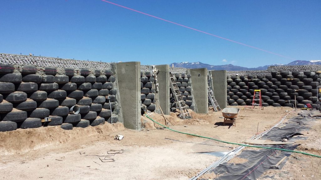 Rammed-earth tire walls under construction