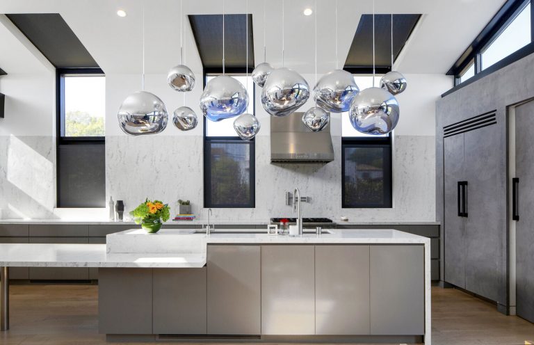 Morningside Remodel kitchen with gray cabinetry and mirrored pendant lights