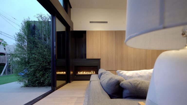 Morningside Remodel living room with linear fireplace opening to the yard