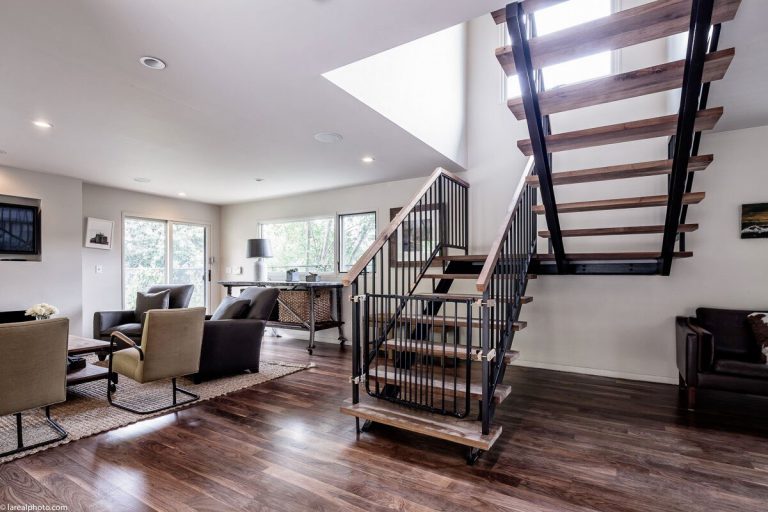 Bayliss Remodel living room with open-riser steel and wood staircase and walnut floors