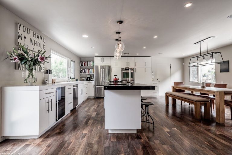 Bayliss Remodel kitchen with white cabinets, island and dining table beyond