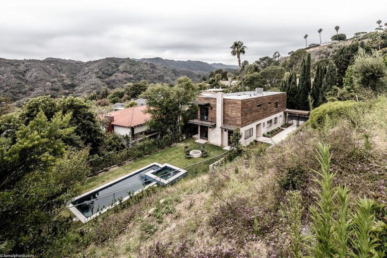 Aerial view of the Bayliss Remodel and pool on a steep hillside