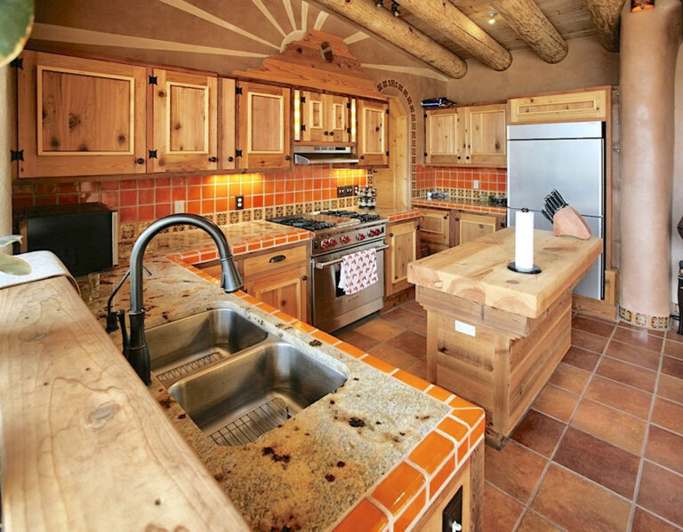 Kitchen with tile counters, knotty-pine cabinets and a butcher-block island