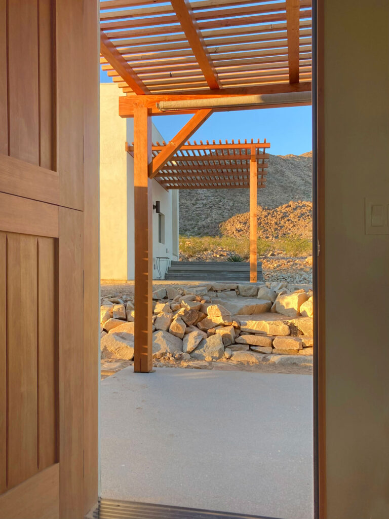 Looking out the entry door to the pergola and hills