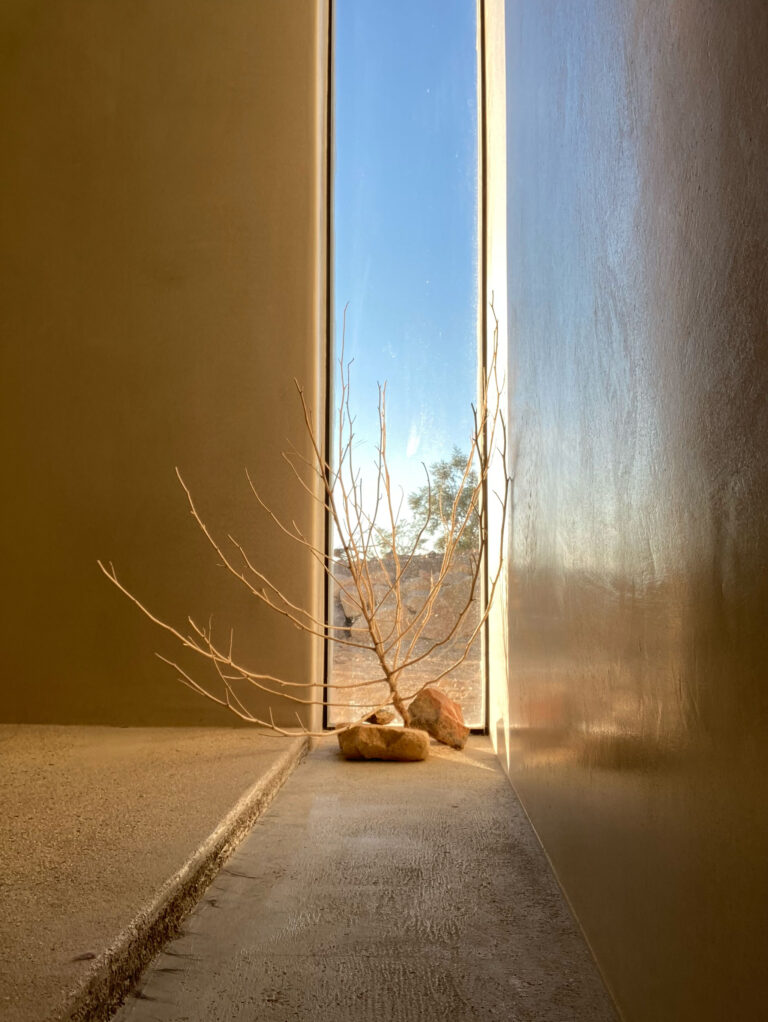 Deep-set slot window in a plaster wall