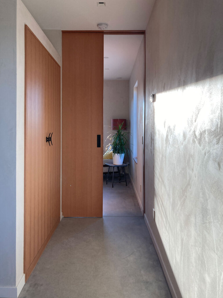 Plaster hallway with tall wood doors